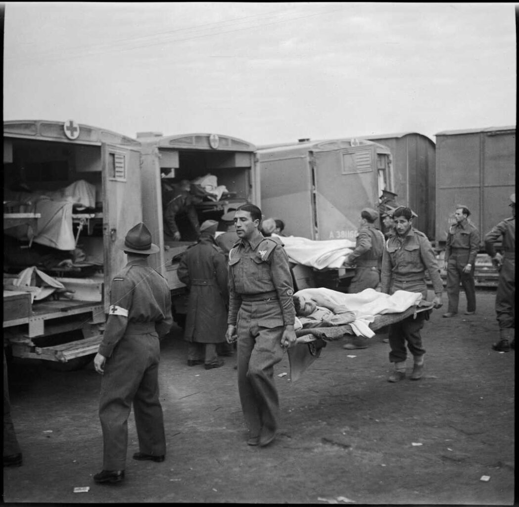 English orderlies carrying wounded soldiers to the hospital ship Maunganui at Port Tewfik, Egypt, in World War II,